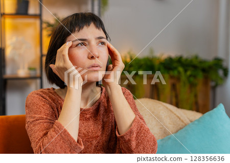 Woman rubbing temples to cure headache problem suffering from tension and migraine stress pain Woman rubbing temples to cure headache problem suffering from tension and migraine stress pain 128356636