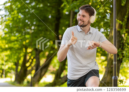 Runner jogger man starting smart watch timer and running checking heart rate monitor before jogging 128356699