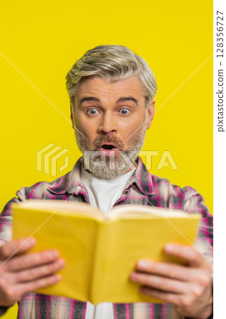 Mature man opening book, amazed face, sudden revelation, instant interest surprising story vibe Mature man opening book, amazed face, sudden revelation, instant interest surprising story vibe 128356727