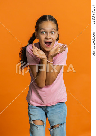Excited child girl kid surprised, shocked by sudden victory, good win news celebrating, wow reaction 128357117