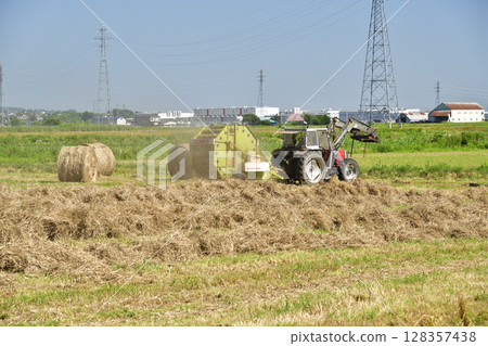 Photographing the work of making hay rolls in Hokuto, Hokkaido in summer 128357438
