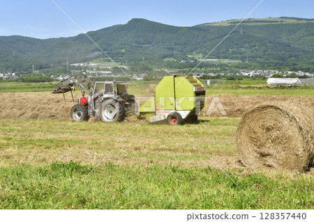 Photographing the work of making hay rolls in Hokuto, Hokkaido in summer 128357440