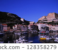 Scenic View of Bonifacio Port in Corsica with Luxury Yachts and Cliffside Town Experience the charm of the French island of Corsica with this stunning image capturing the picturesque port of Bonifacio 128358279