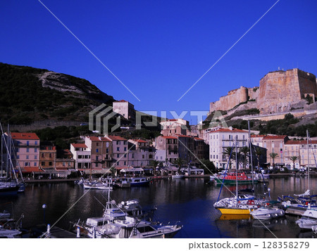 Scenic View of Bonifacio Port in Corsica with Luxury Yachts and Cliffside Town Experience the charm of the French island of Corsica with this stunning image capturing the picturesque port of Bonifacio Scenic View of Bonifacio Port in Corsica with Luxury Yachts and Cliffside Town Experience the charm of the French island of Corsica with this stunning image capturing the picturesque port of Bonifacio 128358279