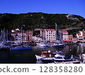 Scenic View of Bonifacio Port in Corsica with Luxury Yachts and Cliffside Town Experience the charm of the French island of Corsica with this stunning image capturing the picturesque port of Bonifacio 128358280