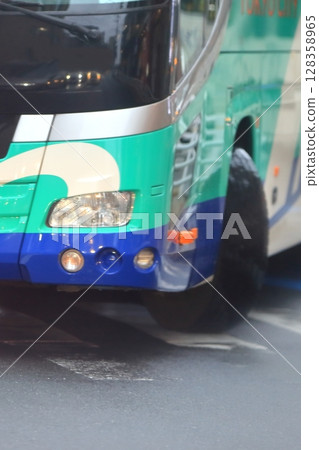 Image of a large bus turning left at an intersection Image of a large bus turning left at an intersection 128358965