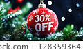 A vibrant red ornament hangs from a fir tree, displaying a 30 off offer. Surrounding lights create a festive atmosphere, embodying the spirit of holiday shopping. 128359364