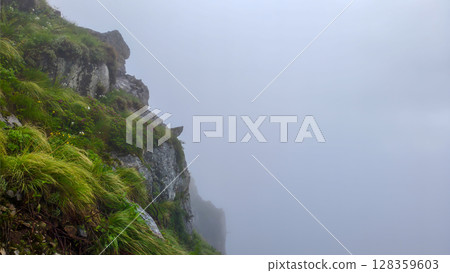 Foggy Cliffside Mountain View Foggy Cliffside Mountain View 128359603