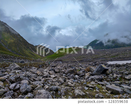 Misty Rocky Highland Vista with Lush Green Hills 128359638