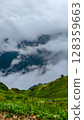 Majestic Misty Mountain Valley with Lush Hills 128359663