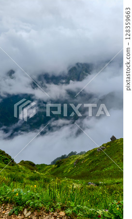 Majestic Misty Mountain Valley with Lush Hills 128359663