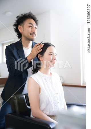 Men and women in hair and makeup styling, finishing image, close-up looking in the mirror 128360297