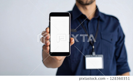 A man showing a smartphone screen A man showing a smartphone screen 128360351
