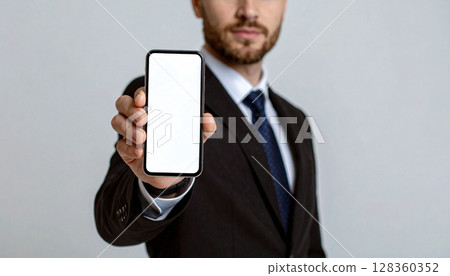 A man showing a smartphone screen A man showing a smartphone screen 128360352