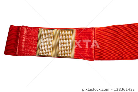 Red fashionable women's knitted elastic band belt with metal buckle with rhinestones, isolated on white background 128361452