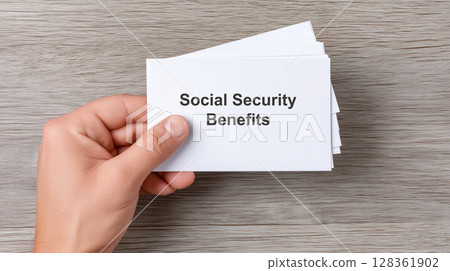 Social security benefits concept, Hand holding a card labeled Social Security Benefits. Social security benefits concept, Hand holding a card labeled Social Security Benefits. 128361902