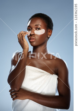 Skincare routine at home with eye patches during self-care time in a serene indoor setting 128362195