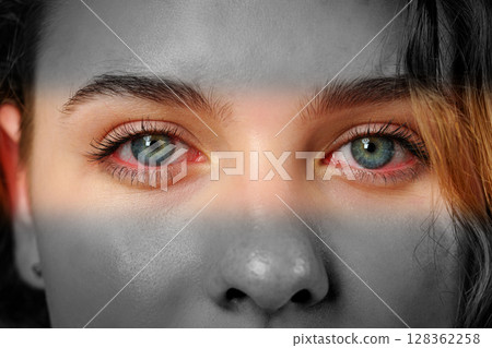 Captivating gaze with striking blue eyes highlighted in a black and white portrait Captivating gaze with striking blue eyes highlighted in a black and white portrait 128362258