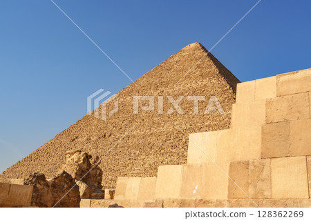 Remarkable view of an ancient pyramid against a clear blue sky in Egypt during midday 128362269