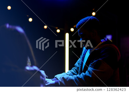 Engaging conversation between two individuals under festive lights at night Engaging conversation between two individuals under festive lights at night 128362423