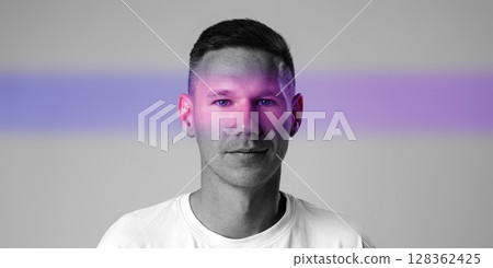 Portrait of a man with colorful light effects in a creative studio setting from a contemporary art perspective 128362425