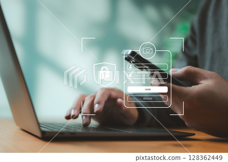 Close-up of two-factor authentication login screen on mobile and laptop. Concept of user security, identity verification, and online business access protection. Close-up of two-factor authentication login screen on mobile and laptop. Concept of user security, identity verification, and online business access protection. 128362449