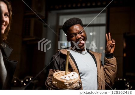 Celebration of friendship with cake at night gathering in urban setting 128362458
