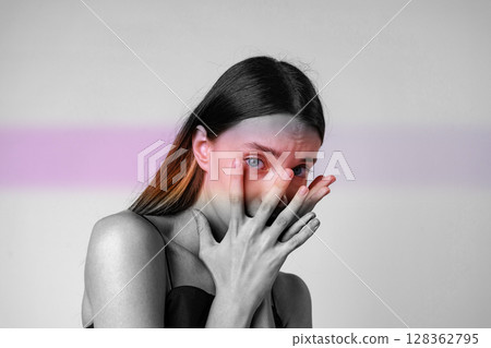 Portrait of a woman expressing emotion with hands covering her face in a minimalist setting during daylight Portrait of a woman expressing emotion with hands covering her face in a minimalist setting during daylight 128362795