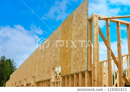 Workers are erecting plywood wall panels wooden frames on new construction site under works day Workers are erecting plywood wall panels wooden frames on new construction site under works day 128362811