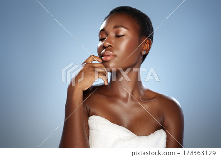 Portrait of a woman with beautiful skin and short hair showcasing elegance and serenity against a soft blue background 128363129