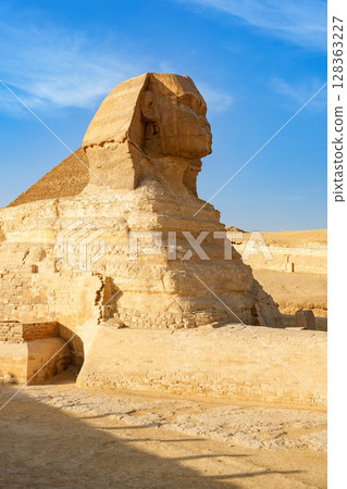 Grand view of the Great Sphinx at Giza under clear blue sky during midday light 128363227