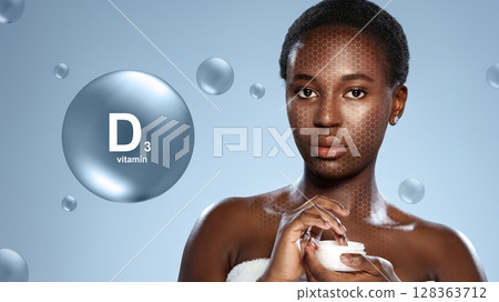 Woman applying vitamin D3 cream on her face with a smooth, glowing skin background in a skincare setting 128363712