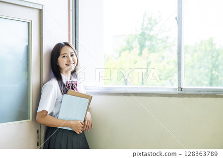 Portrait of a high school girl looking at camera smiling 128363789