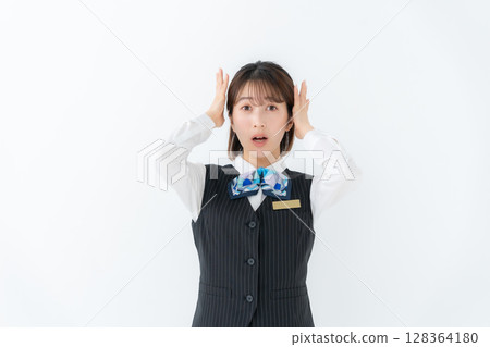 Young woman in uniform, business, surprised 128364180