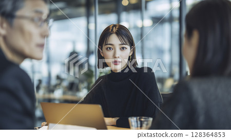 A scene of multiple business people having a meeting in an open office A scene of multiple business people having a meeting in an open office 128364853