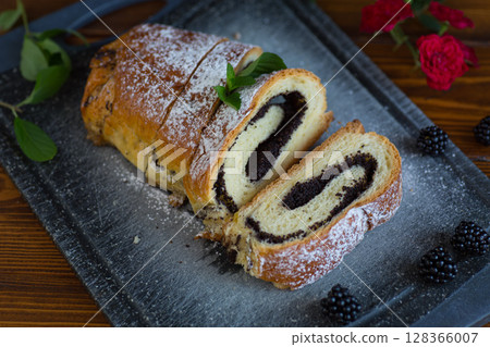 Delicious fresh pastries with poppy seed filling on the table 128366007
