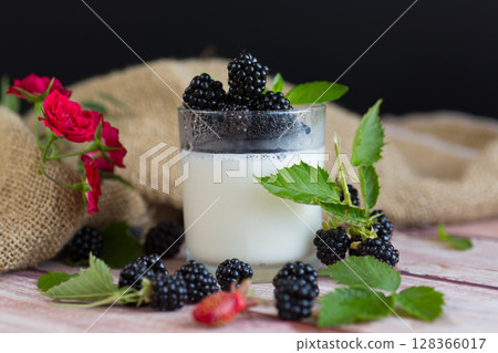 Summer dessert of yogurt with berries and flowers Summer dessert of yogurt with berries and flowers 128366017