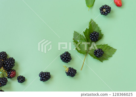 Natural summer berries with shine and details on a green background 128366025