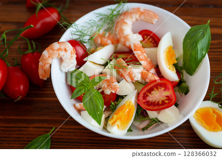 Salad with protein and greens on a wooden board Salad with protein and greens on a wooden board 128366032