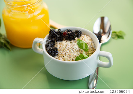 Bowl with dry cereal and berries on the background 128366054