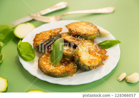 Fried zucchini with garlic and basil served hot Fried zucchini with garlic and basil served hot 128366057
