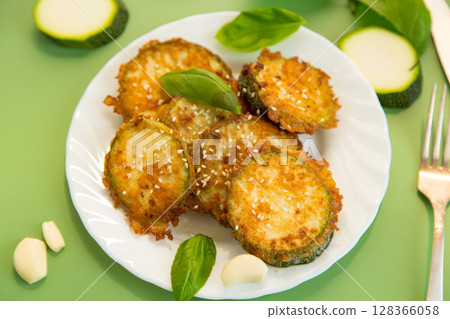 Summer vegetable appetizer of fried zucchini and sesame seeds 128366058