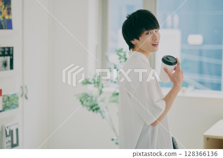 Young man doing desk work Young man doing desk work 128366136