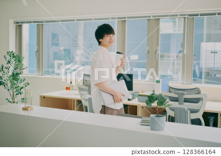 Young man doing desk work Young man doing desk work 128366164