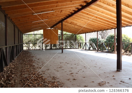 A Spacious Indoor Area Featuring a Beautiful Wooden Roof and a Leafy Floor Design A Spacious Indoor Area Featuring a Beautiful Wooden Roof and a Leafy Floor Design 128366376