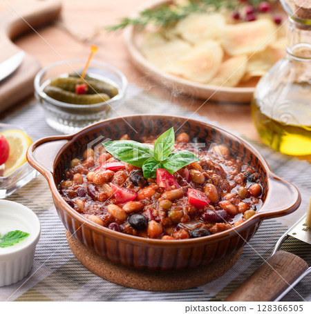 A colorful Western-style table with lots of ingredients and chili con carne 128366505