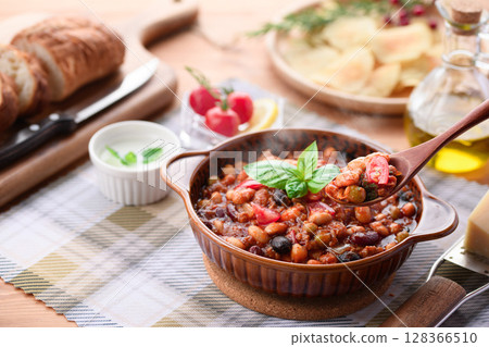 A colorful Western-style table with lots of ingredients and chili con carne 128366510