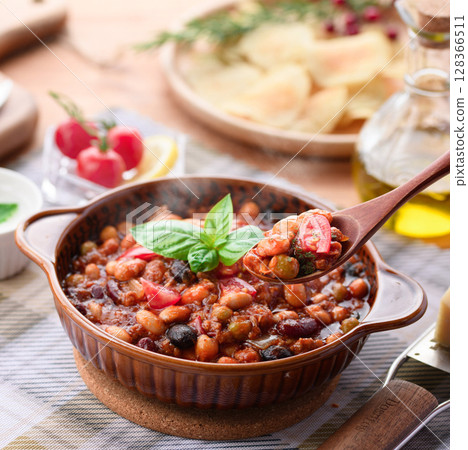 A colorful Western-style table with lots of ingredients and chili con carne 128366511