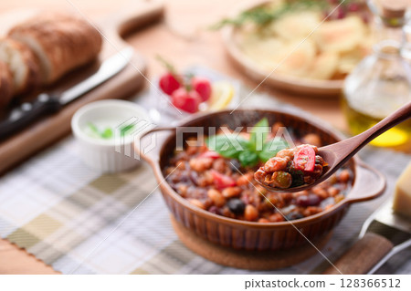 A colorful Western-style table with lots of ingredients and chili con carne 128366512
