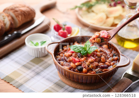 A colorful Western-style table with lots of ingredients and chili con carne 128366518
